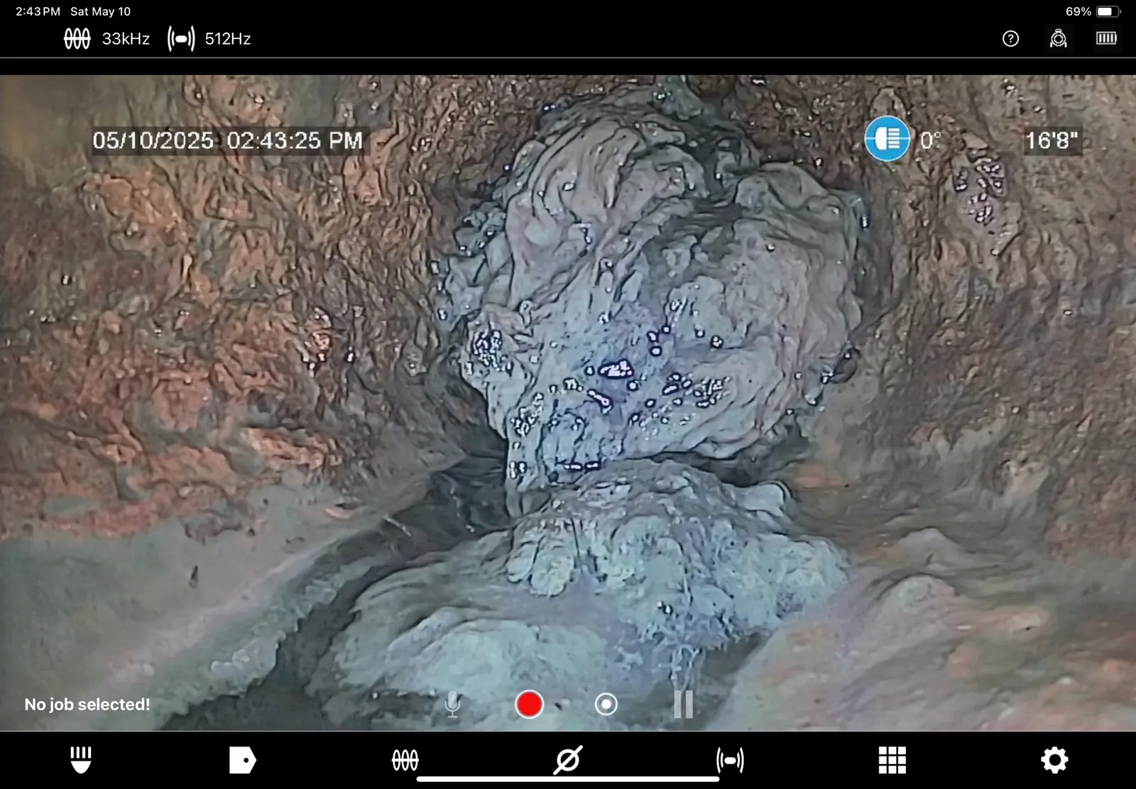 Sewer camera capture dated May 10, 2025 showing buildup 16 feet 8 inches into the line